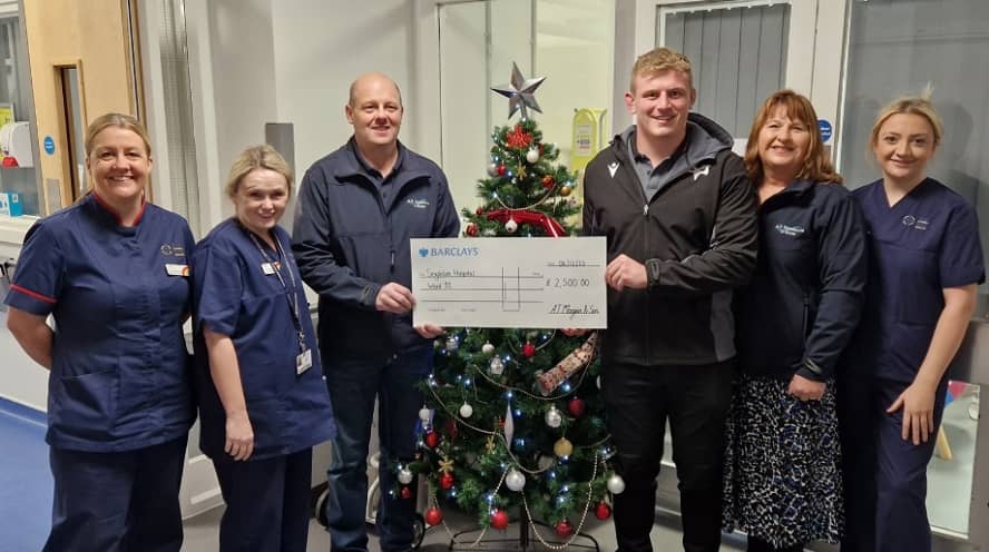 Photo of Helen Morgan and colleagues presenting a chque to Singleton Hospital’s oncology and haematology ward