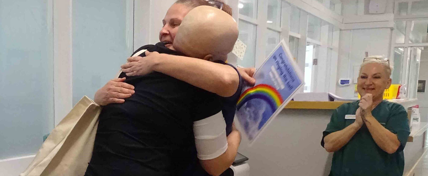 A big hug for patient Jo Gwinnett from Chemotherapy Day Unit sister Allison Church, watched by health care support worker Carolyne Paddison